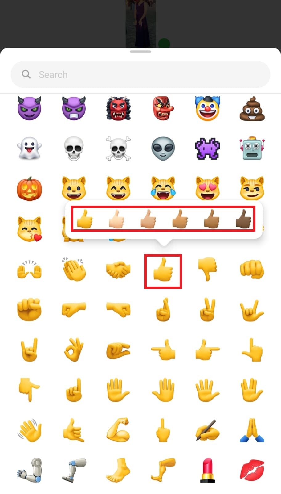 Scroll down, tap and hold the thumbs-up emoji and select the skin color you want.